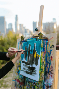 kid painting on an easel